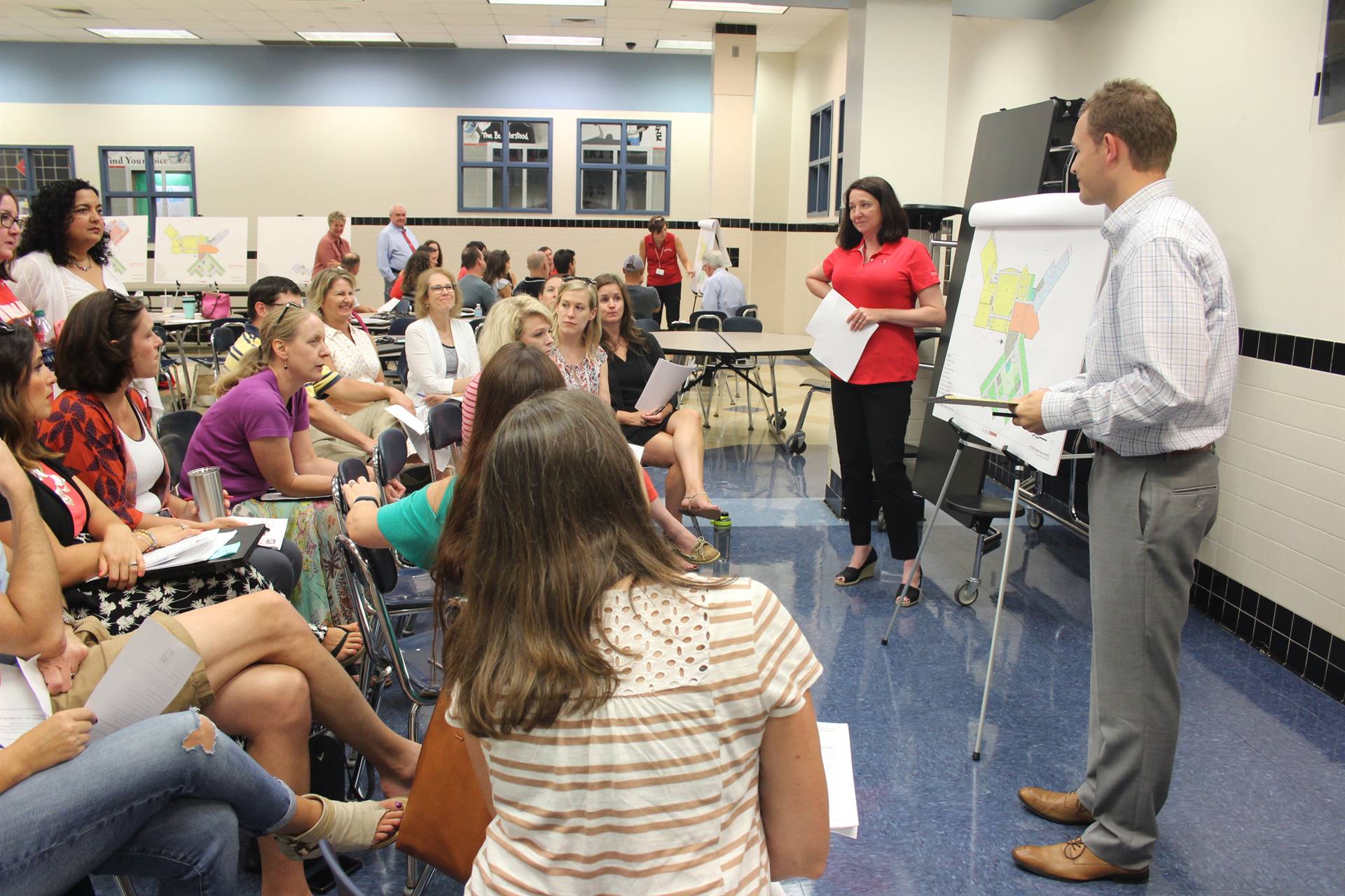 Staff members view plans and give feedback.