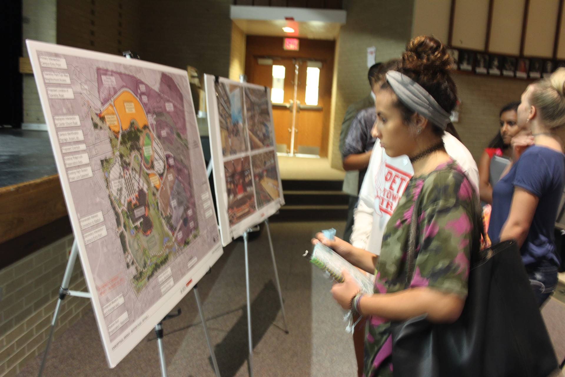 Student looks over site plan for the school.