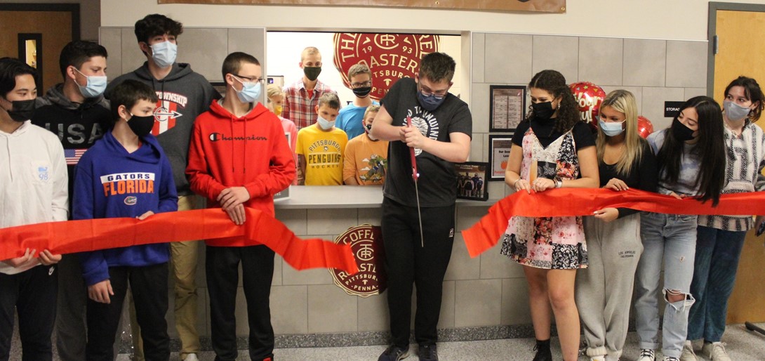 Students cut the ribbon at Coffee Tree Roasters.