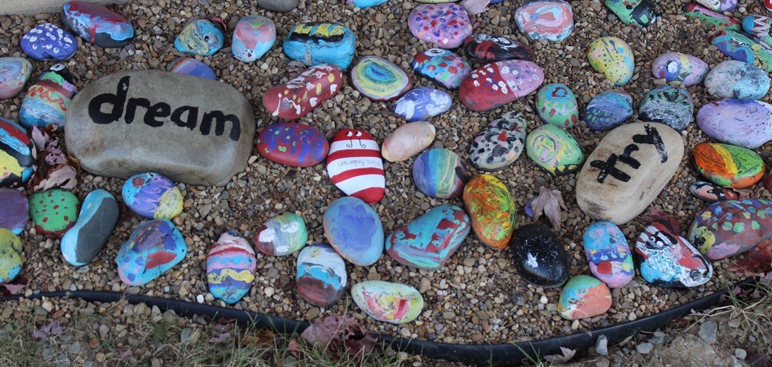 rock garden with positive messages painted on rocks.