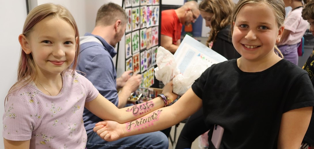 Students with temporary tattoos that say &#34;Best Friends&#34;