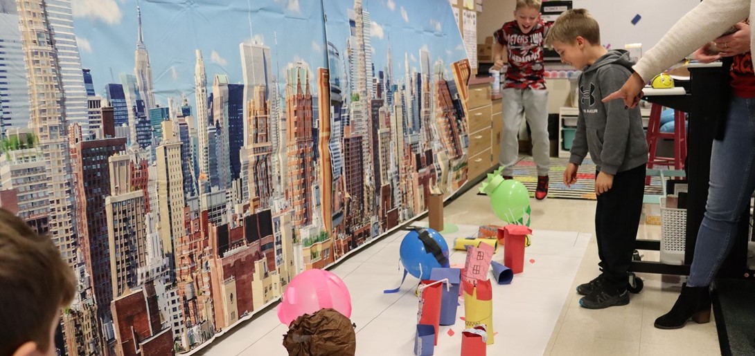 Students cheer as their robots make it through the parade route.