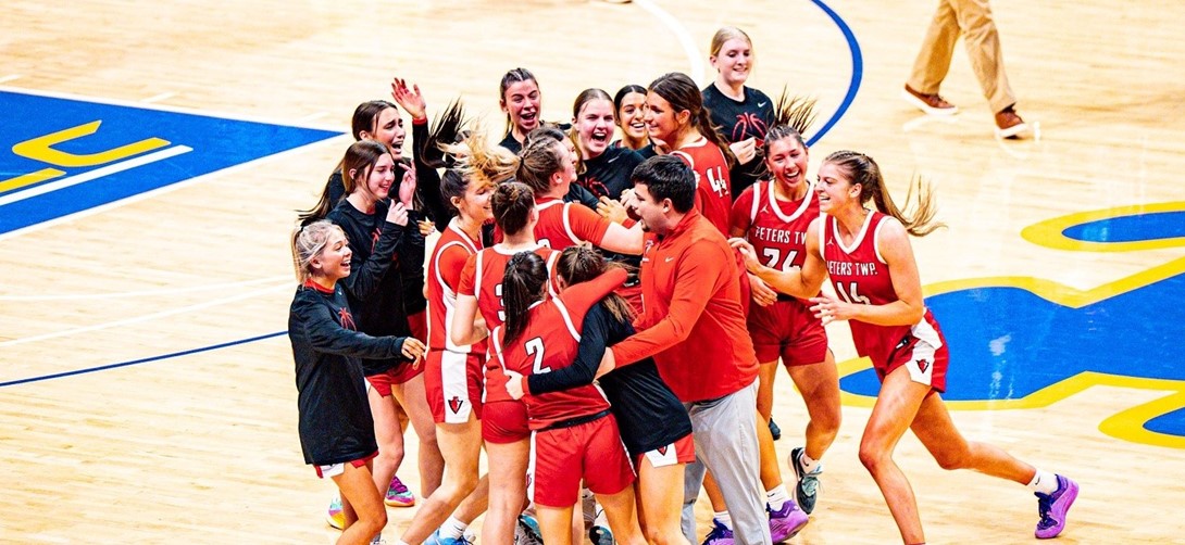 Team members celebrate the win on the court.