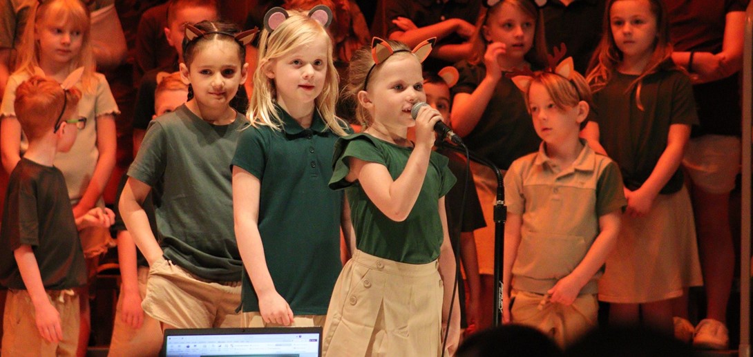Students speak their lines in to the microphone during the show.