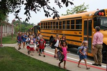 Student getting off the bus at school.